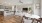 a large kitchen with a large dining table and a large white couch