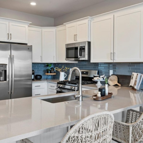 Spacious kitchens with thoughtful details a kitchen with white cabinets