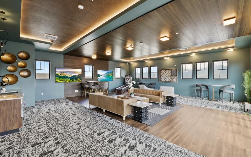 a room with a large rug and tables and chairs