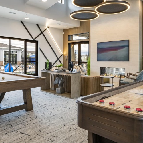 Settle into comfort at Viviano at Riverton a room with tables and chairs