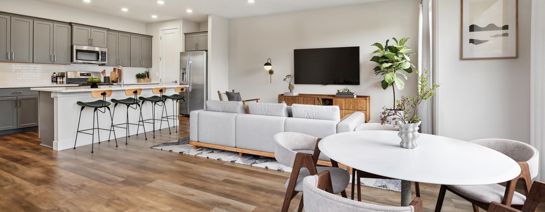 a large kitchen with a large dining table and a large white couch